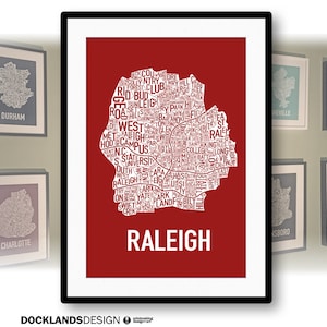May include: A red typography map of Raleigh, North Carolina, with the city name printed in white at the bottom. The map is made up of the names of neighborhoods and landmarks within the city.