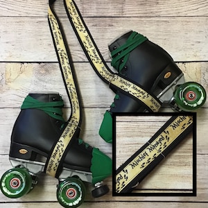 May include: A pair of black roller skates with green laces, green toe caps, and translucent green wheels. A cream-colored strap with the repeating text "Mischief Managed" and black footprint graphics is attached to the skates for carrying.