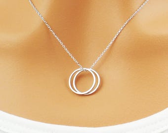 Choose gold, silver or mixed double karma eternity circle necklace. Elegant and dainty double circle infinity necklace pendant