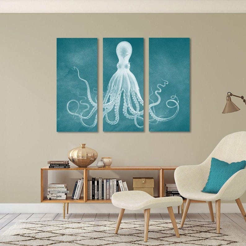 a living room with a large wall art piece depicting a white octopus with long tentacles. The room is furnished with a white armchair, a wooden bookshelf, and a small table with a vase and a lamp.