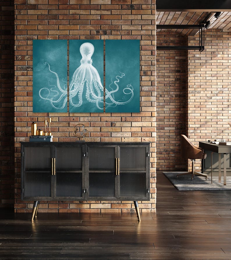 a modern interior design with a large, three-piece wall art depicting an octopus. The wall art is mounted on a brick wall, and the room includes a black cabinet, a desk, and a chair.