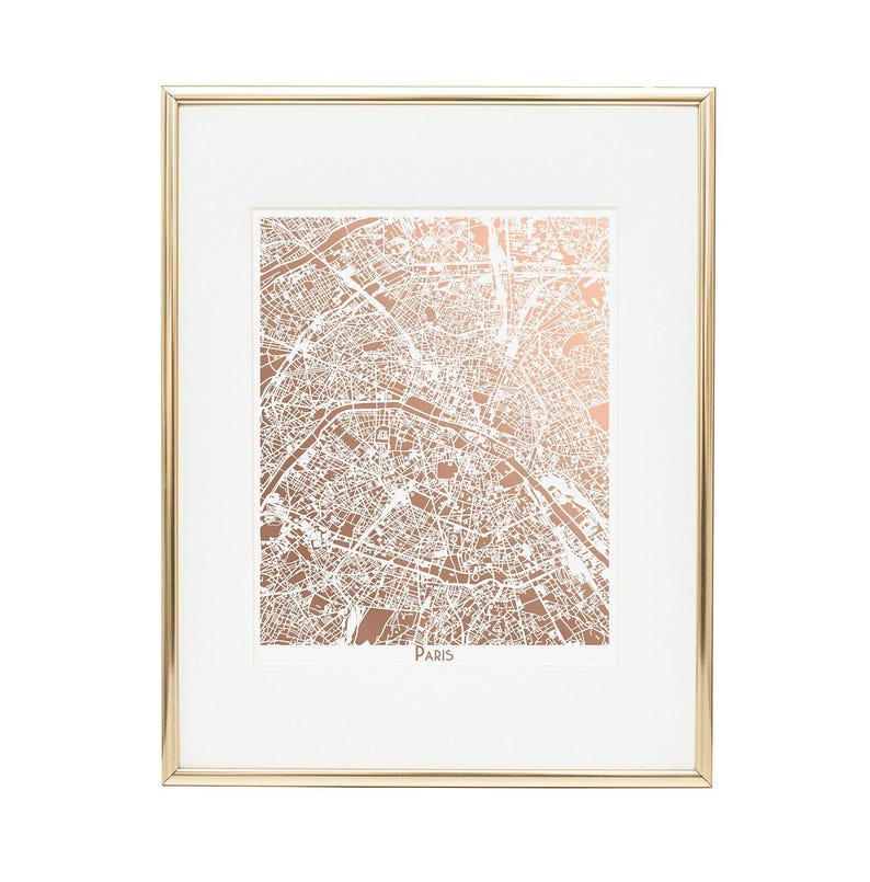A rose gold foil map of Paris shown in a gold frame.