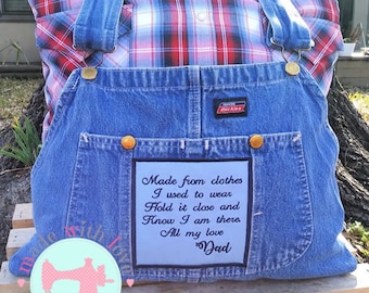 May include: A blue denim pillow with a red and blue plaid fabric insert. The pillow has a pocket with the text "Made from clothes I used to wear Hold it close and Know I am there All my love Dad" embroidered on it.