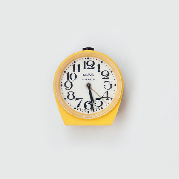 Vintage yellow mechanical alarm clock "Slava"