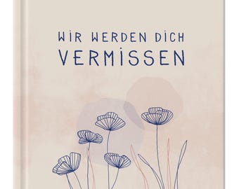 May include: A beige book with the text "Wir werden dich vermissen" in blue lettering. The background features a watercolor-like design of pink and purple circles and blue stylized flowers.