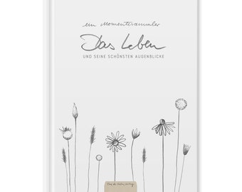 May include: A white journal cover with the text "ein momentenraumler Das Leben und seine schönsten augenblicke" and a drawing of wildflowers in black and white.