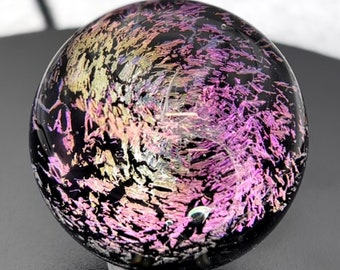 Handmade marble using Borosilicate glass, with colours of pink, purple and yellow running throughout and a touch of shimmer from dichroic.