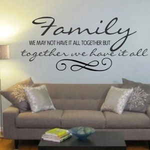 May include: A living room with a gray couch and a quote on the wall that reads "Family We may not have it all together but together we have it all".