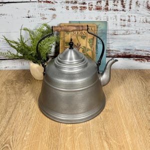 May include: A set of three ceramic mugs with a speckled, matte finish. The mugs are in shades of cream, light gray, and dark gray. Each mug has a simple, minimalist design, perfect for coffee or tea.
