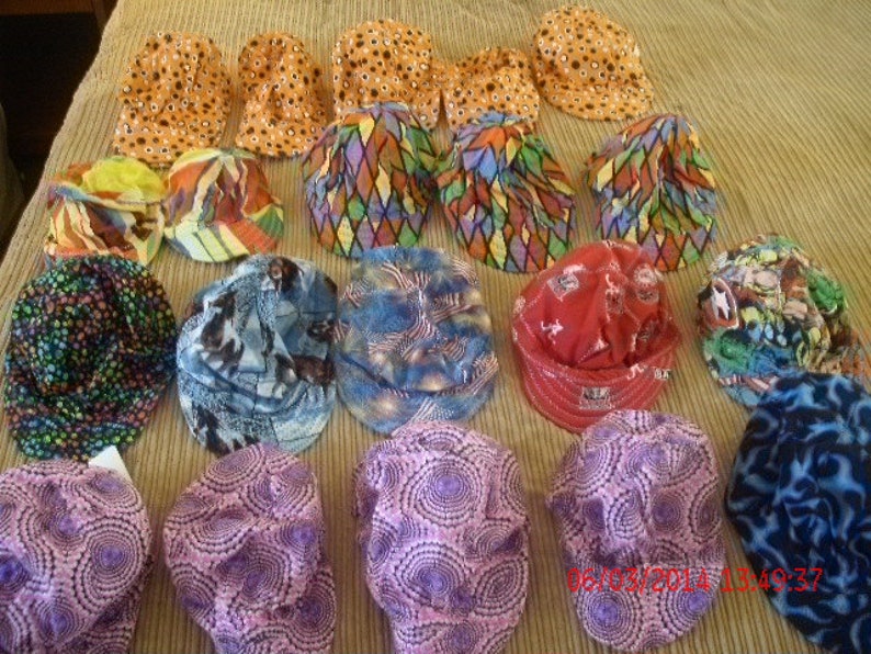 K&ouml;nnte beinhalten: Eine Sammlung von 16 bunten H&uuml;ten mit verschiedenen Mustern und Designs. Die H&uuml;te sind aus Stoff und haben eine Vielzahl von Farben, darunter Blau, Rot, Gr&uuml;n, Gelb, Orange und Lila.