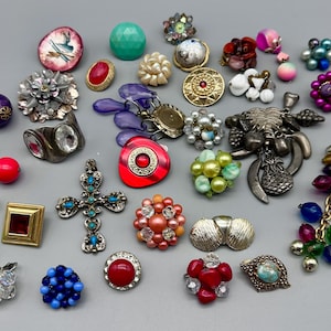 May include: A collection of colourful and unique jewellery pieces, including earrings, pendants, and brooches. The jewellery features a variety of materials, such as glass, metal, and beads.
