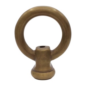 May include: A brass ring with a round base. The ring is smooth and has a polished finish.