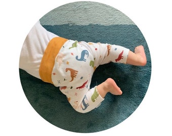 Calças de bebé Dinossauros | Leggings de algodão orgânico para bebé e criança | Calças saruel em malha para bebé com Dinossauros e folhas