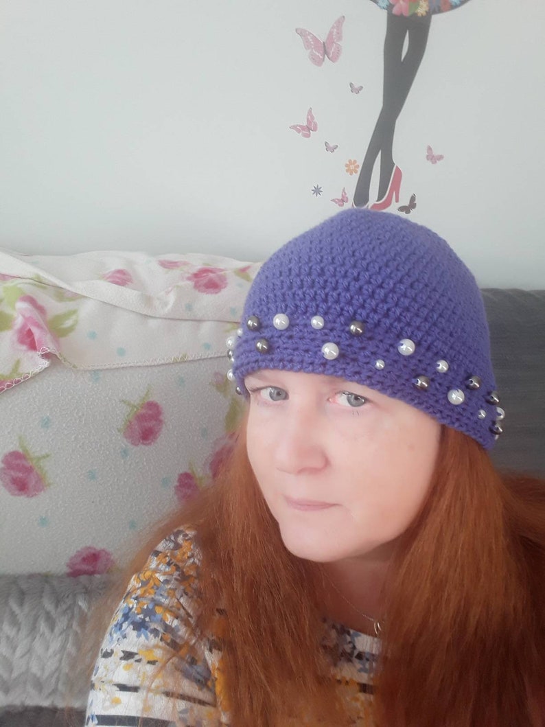 womans hand crocheted Purple winter hat with beaded trim