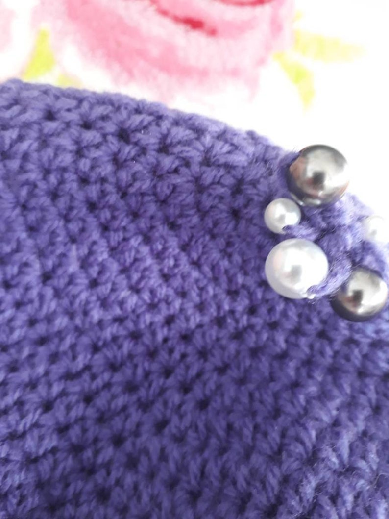 womans hand crocheted Purple winter hat with beaded trim
