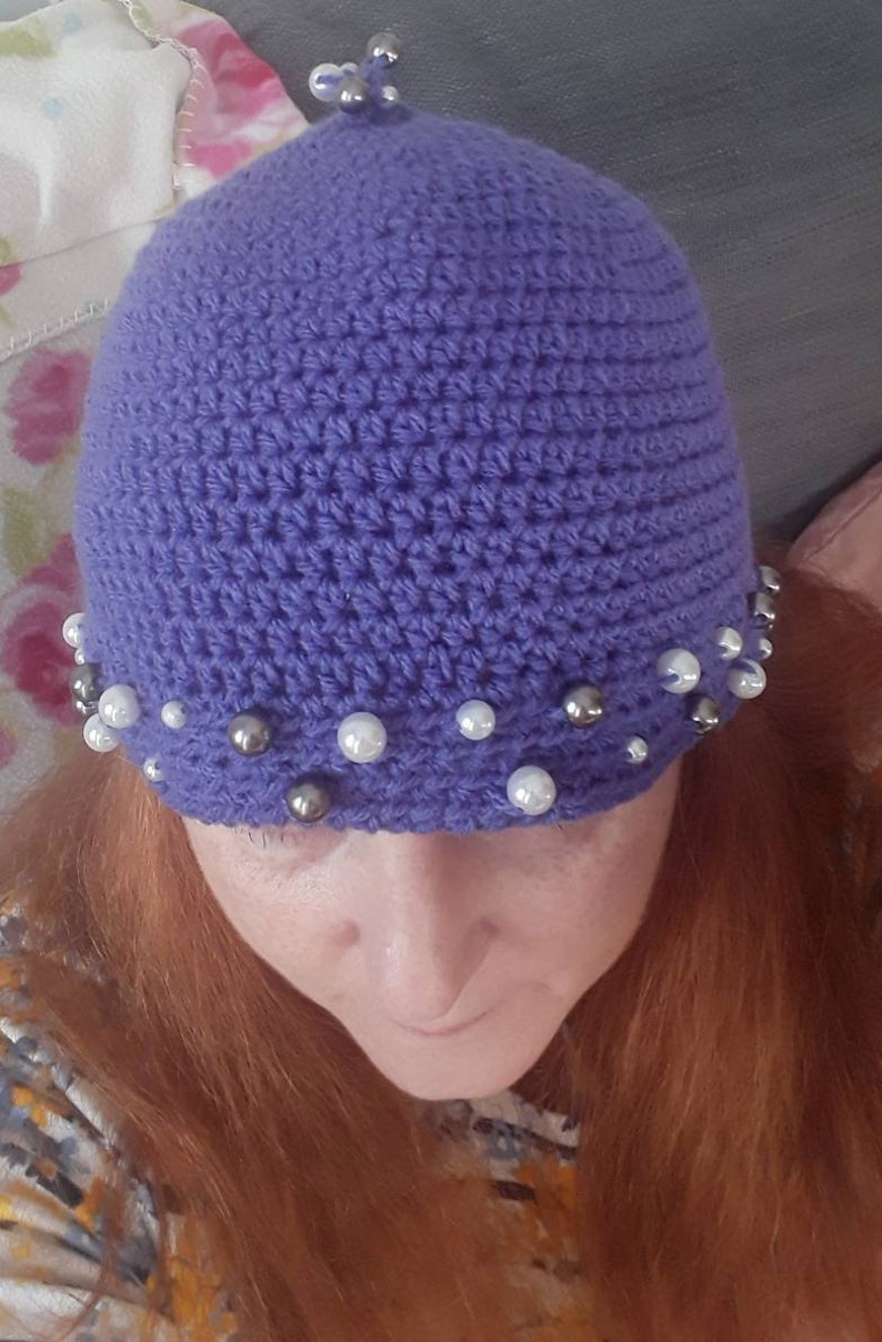 womans hand crocheted Purple winter hat with beaded trim