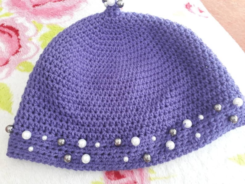 womans hand crocheted Purple winter hat with beaded trim
