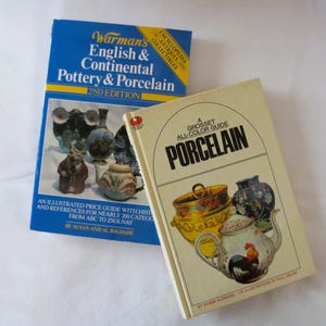 May include: Two vintage books on porcelain and pottery. One book is titled "Warman's English & Continental Pottery & Porcelain" and the other is "A Grosset All-Color Guide Porcelain". Both books feature colorful illustrations.