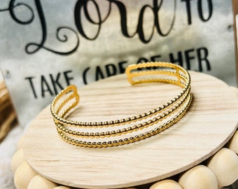 Gold triple dotted pattern cuff bracelet, stainless steel