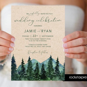 May include: A rustic wedding invitation with a watercolor illustration of a mountain range and pine trees. The invitation is printed on kraft paper and includes the names Jamie and Ryan, the date Friday, September 22nd, 2025, the time 5:00 in the evening, and the location Tobacco Barn Farm, 18503 MO-33, Holt, MO 64048. The invitation also includes the text "Reception to follow".