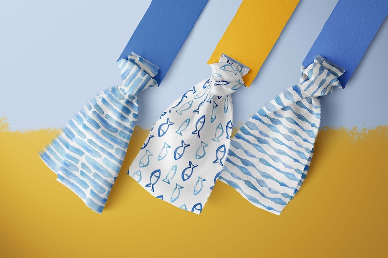 May include: Three fabric swatches with different blue and white patterns. The swatches are tied in knots and are displayed against a blue and yellow background. The patterns include a blue and white striped pattern, a white background with blue fish, and a blue and white wavy pattern.