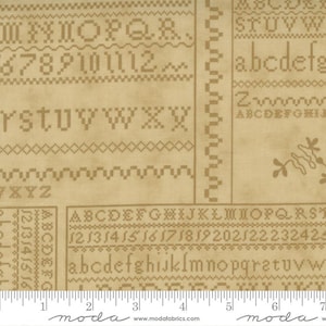 May include: Tan fabric with cross-stitch style alphabet letters, numbers, and decorative stitches. The fabric includes a ruler along the bottom edge with the Moda Fabrics logo.