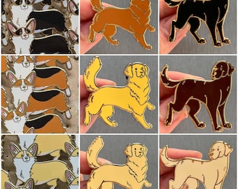 May include: Set of nine enamel pins featuring different dog breeds. The pins are gold, brown, black, and cream coloured. The dogs are depicted in a cartoon style.