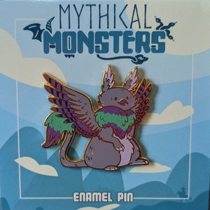 May include: A purple and green enamel pin of a mythical creature with wings. The creature has a grey body, a purple and green feathered mane, and purple and gold wings. The pin is on a blue and white background with the text "Mythikal Monsters" and "Enamel Pin".