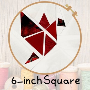 May include: A red and white fabric quilt block in a 6-inch square hoop. The block is made of red fabric triangles arranged in a geometric pattern.
