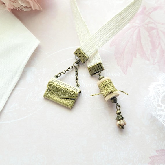 A tiny working locket disguised as a bookmark — opens like an antique gold envelope, making it a genuinely clever dual-purpose keepsake for readers.
