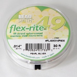 May include: A spool of Beadsmith Flex-Rite 49 strand nylon-coated stainless steel micro-wire in pearl silver. The spool is labelled with the product name, size, and length: 0.014" (35 mm), 30 ft (9.14 m).