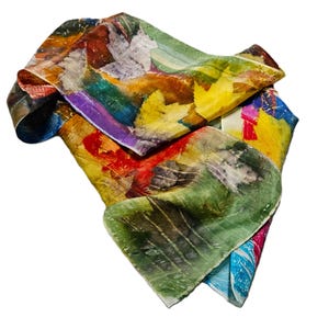 May include: A colorful silk scarf with an abstract design. The scarf features a mix of vibrant colors including yellow, green, red, and purple. The design includes leaf-like shapes and brushstrokes, creating a unique and artistic accessory.