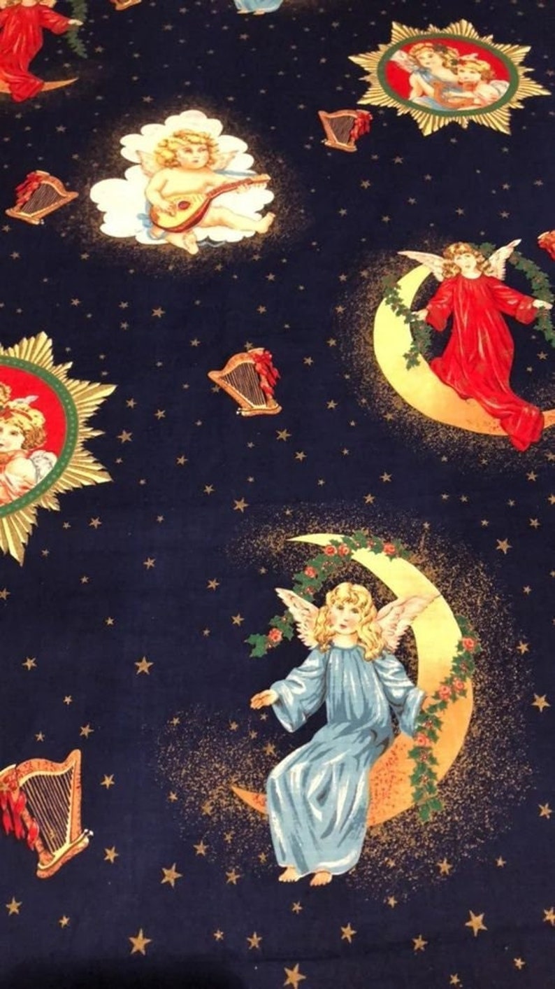 May include: Dark blue fabric with a repeating pattern of cherubs, harps, and stars. Cherubs are depicted playing instruments and seated on crescent moons. The cherubs wear robes in shades of red and blue. Gold stars and accents complete the design.