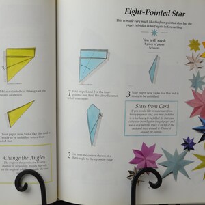 May include: A book with instructions on how to make origami stars. The book shows diagrams of how to fold the paper and cut it to make a pointed star and an eight-pointed star. The book also includes a section on how to make stars from card.
