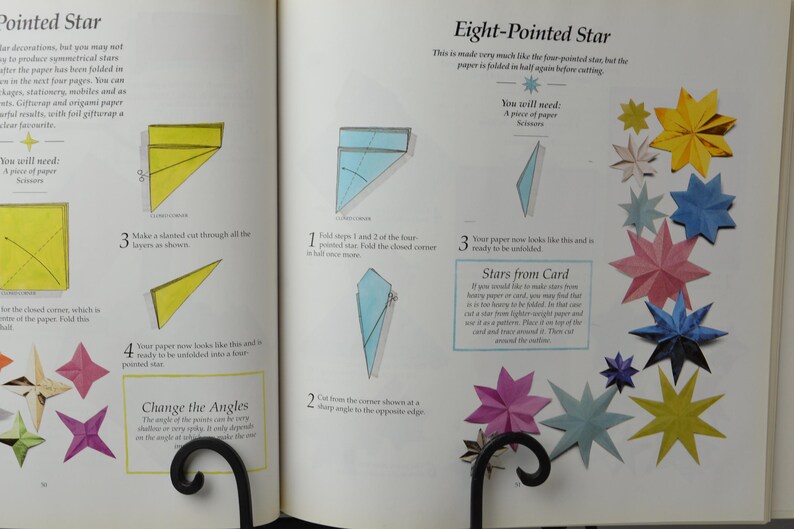 May include: A book with instructions on how to make origami stars. The book shows diagrams of how to fold the paper and cut it to make a pointed star and an eight-pointed star. The book also includes a section on how to make stars from card.
