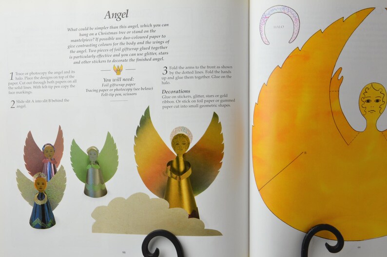 May include: A craft project for making a paper angel ornament. The instructions include using tracing paper, gift wrapping paper, scissors, and a felt tip pen. The finished angel is decorated with glitter, stars, or gold ribbon.