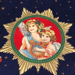 May include: A navy blue fabric with a repeating pattern of gold stars and a central medallion. The medallion features two cherubic figures with wings, one playing a harp, set against a red and green background.