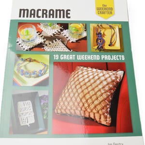 May include: A softcover book titled Macrame: 19 Great Weekend Projects by Jim Gentry. The cover features a green background with multiple photographs of macrame items, including coasters, a necklace, a bracelet, and a decorative pillow.