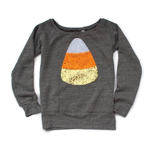 May include: A grey long-sleeved sweatshirt with a candy corn design made of sequins. The candy corn is orange, yellow, and white.