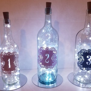 Wine bottle Centerpieces with table number and cork lights/ Wedding Wine bottle centerpieces/ table number centerpieces/bottle centerpieces