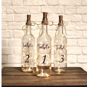 Lighted Wine bottles /Lighted bottle table number / Lighted Wedding Wine bottle centerpieces/ table number centerpieces/bottle centerpieces