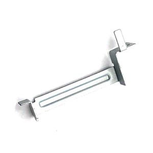 May include: A silver-colored metal bracket with a rectangular body and two angled tabs. The bracket has a channel running along its length and a small, raised section at one end. The object is set against a white background.