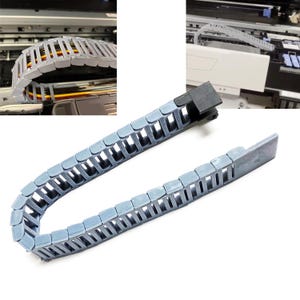 May include: A gray plastic cable chain with a black connector. The chain is flexible and can be used to protect cables from damage.