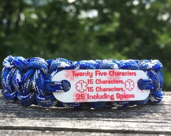 May include: A blue and white paracord bracelet with a white plastic tag that says "Twenty Five Characters, 15 Characters, 15 Characters, 25 Including Spaces".