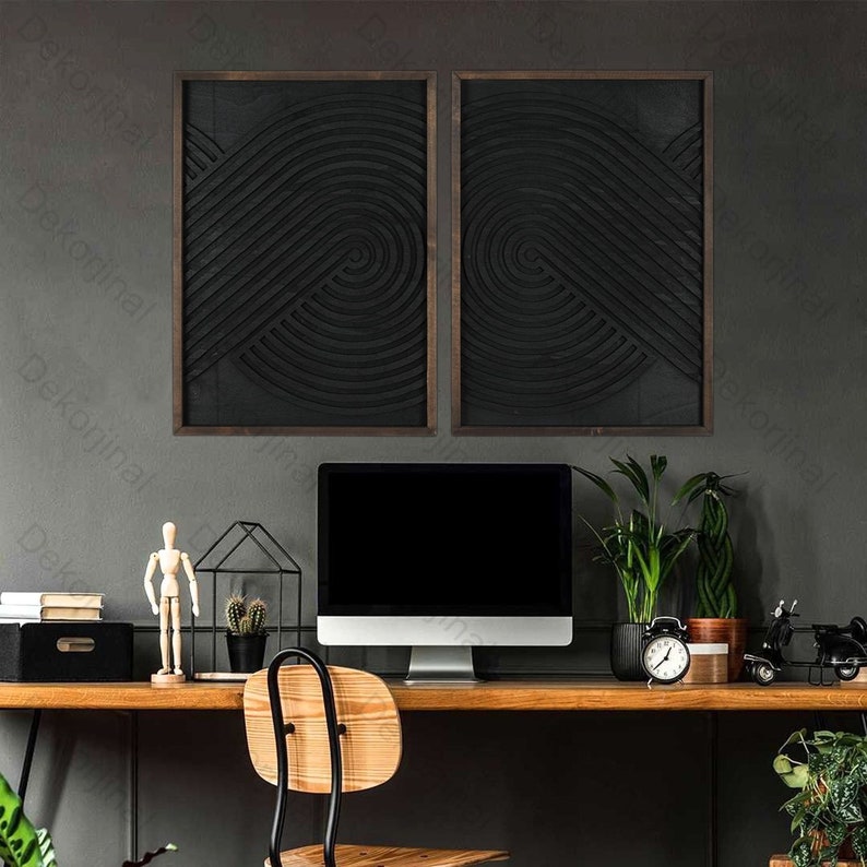 May include: Two black and white abstract geometric wall art pieces with a wood frame, a black computer monitor, a wooden desk, a wooden chair, a potted plant, a wooden figurine, a potted cactus, and a clock on the desk.
