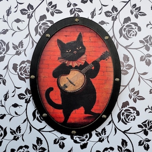 Schwarze Katze mit Banjo Wandkunst - Wunderlicher ovaler Rahmen mit gotischem Akzent - Handgefertigtes Musikkatzendesign für ein gemütliches und einzigartiges Zuhause
