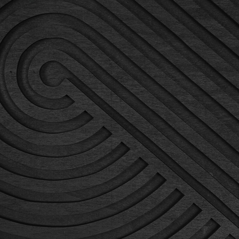 May include: Abstract black and white geometric pattern with concentric circles and diagonal lines. The pattern is created by cutting out sections of the surface, creating a 3D effect.