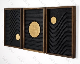 May include: Three black wood framed wall art panels with a geometric design. The center panel features a large gold circle, while the other two panels feature a wavy pattern with a smaller gold circle.