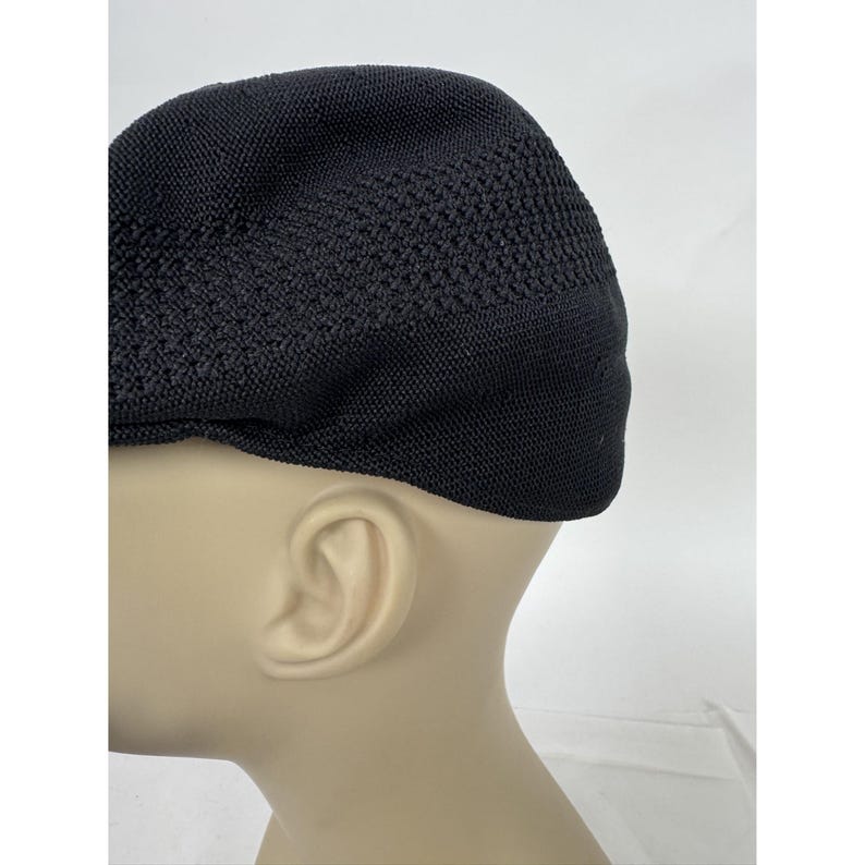 May include: Black knit cap with a textured pattern. The cap is made of a soft, flexible material and has a classic design. This hat is suitable for various occasions and offers a comfortable fit.