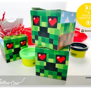 May include: Three green and brown Minecraft character favor boxes with red hearts for eyes. The boxes are stacked on top of each other. The top box has a blue sky with white clouds on the top. The boxes are sitting on a white surface. Treats not included.